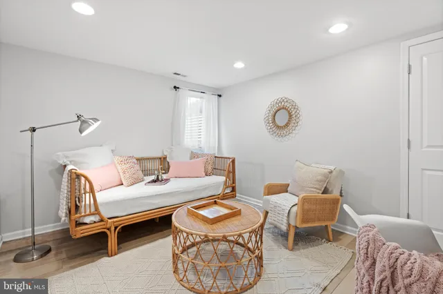 a living room with furniture a rug and a window