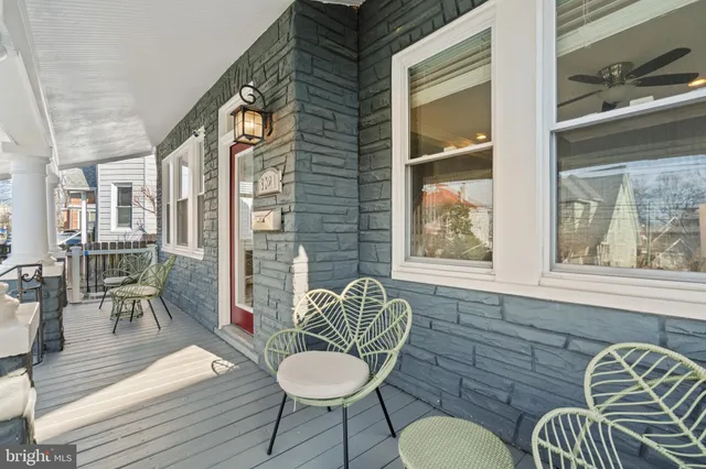 a balcony with chairs and a table