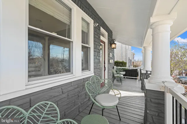 a balcony with chairs and table