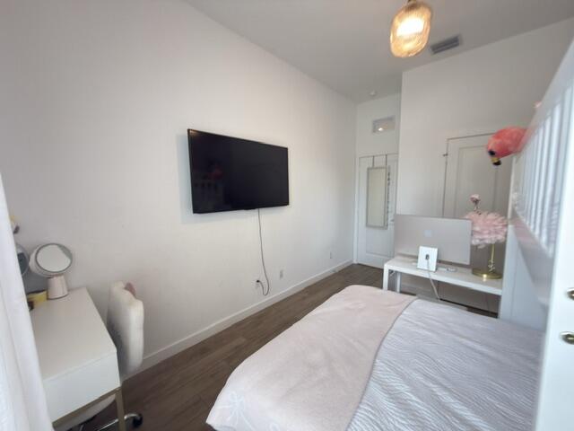 19696 Weathervane Way Loxahatchee, FL 33470 - Photo 24 of 39 a bedroom with a bed and a flat screen tv