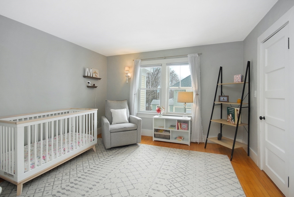 32 Highland Street Concord, MA 01742 - Photo 11 of 28 a living room with furniture and a baby crib