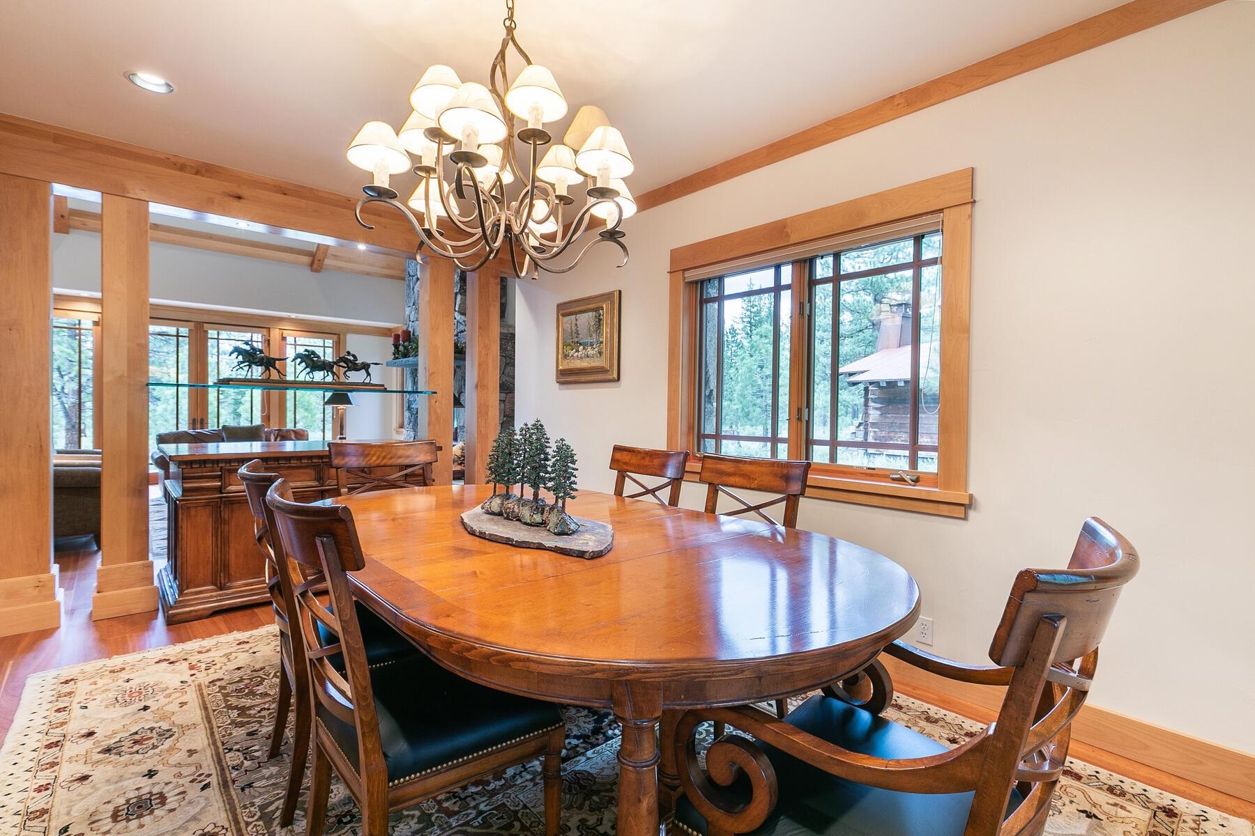 8433 Jake Teeter Drive Truckee, CA 96161 - Photo 11 of 21 a dining room with furniture a chandelier and wooden floor