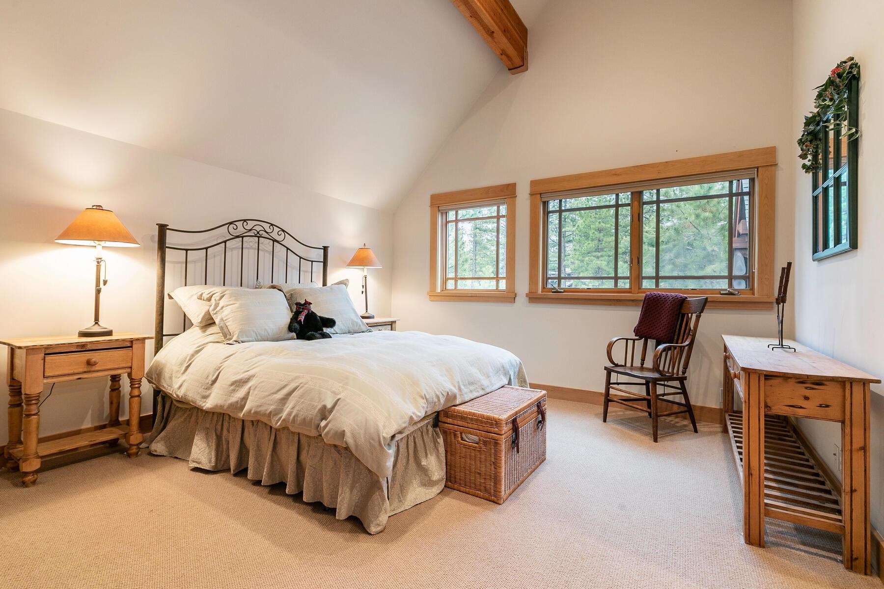 8433 Jake Teeter Drive Truckee, CA 96161 - Photo 18 of 21 a spacious bedroom with a bed and a chandelier