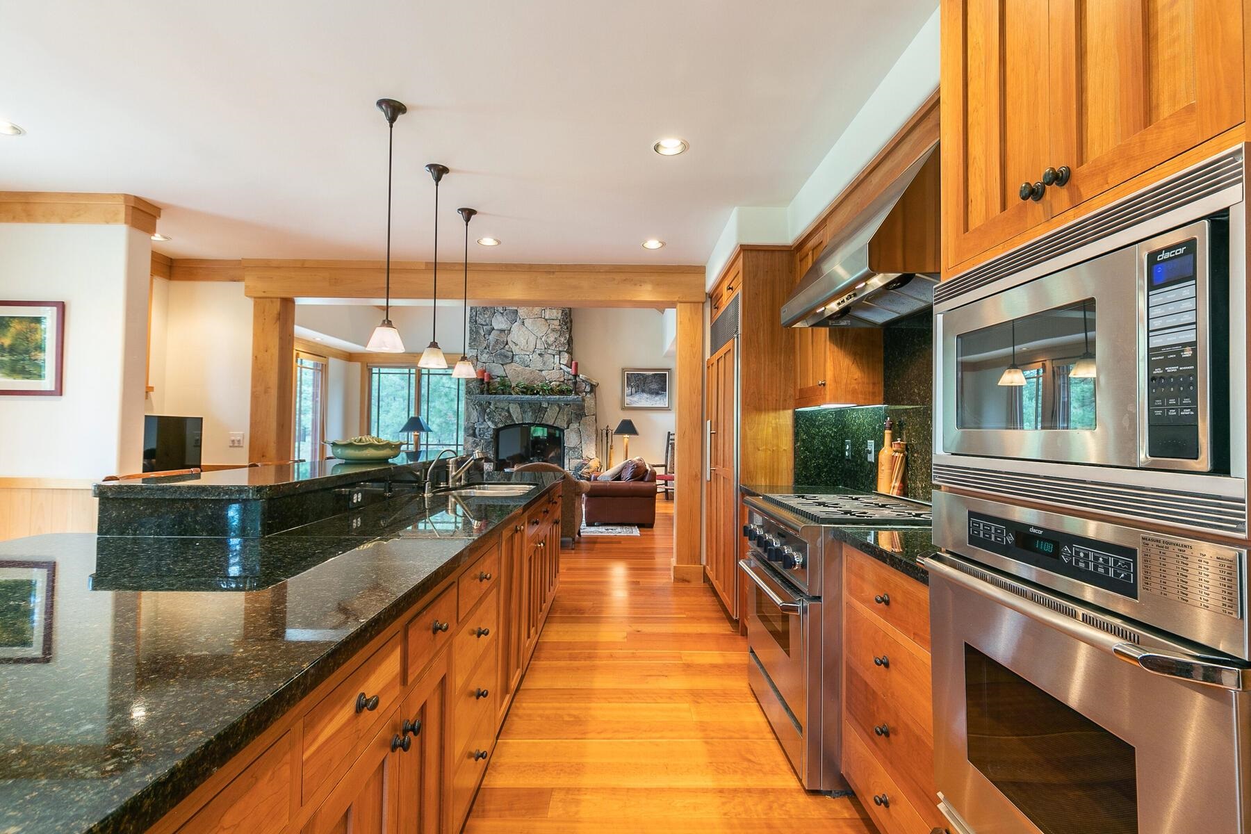 8433 Jake Teeter Drive Truckee, CA 96161 - Photo 9 of 21 a large kitchen with stainless steel appliances a stove a sink and a wooden floors