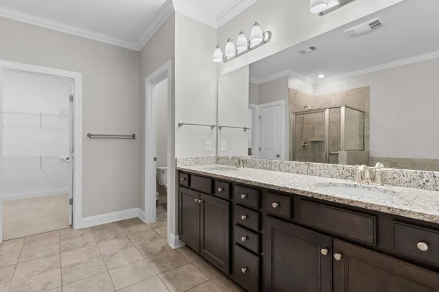 a bathroom with a double vanity sink and a mirror