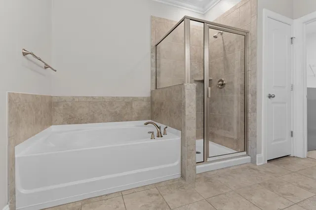a white bath tub sitting next to a shower