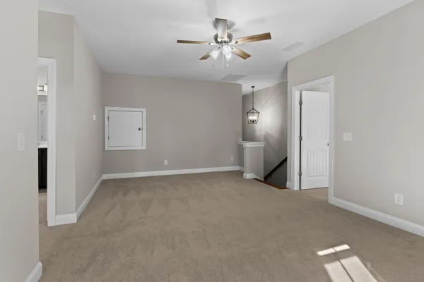 a view of an empty room with a ceiling fan