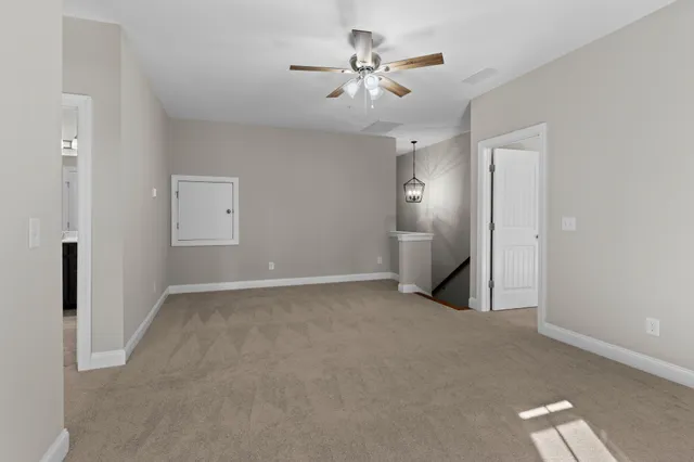 a view of an empty room with a ceiling fan