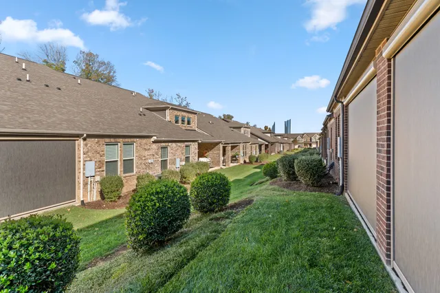a view of a house with backyard and garden