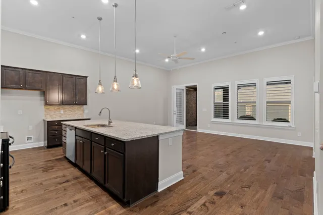 a kitchen with a stove sink and cabinets