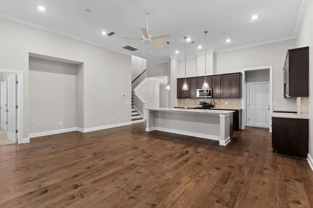 a view of kitchen with microwave stove top oven and refrigerator