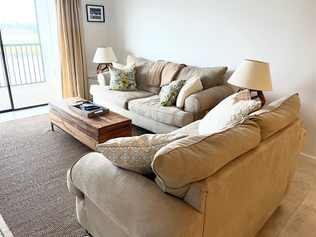 40 Northeast Plantation Road, Unit 208 Stuart, FL 34996 - Photo 25 of 38 a living room with furniture and a couch