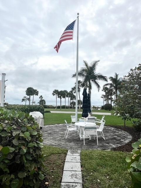 40 Northeast Plantation Road, Unit 208 Stuart, FL 34996 - Photo 38 of 38 a swimming pool with outdoor seating and garden