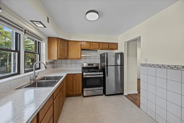 a kitchen with granite countertop a refrigerator and a sink