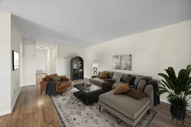 a living room with furniture wooden floor and a potted plant