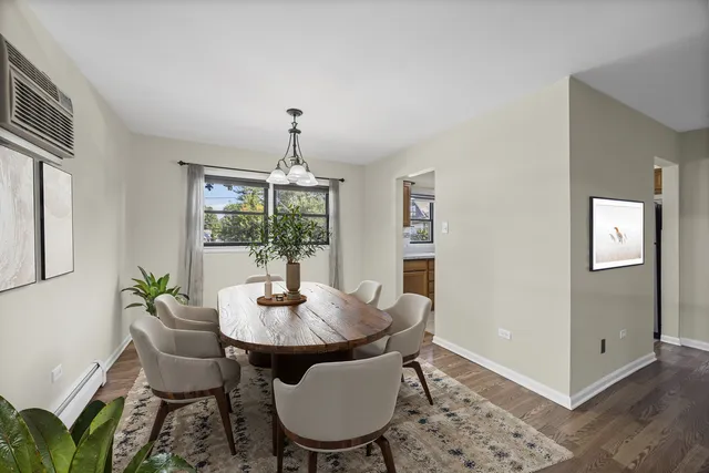 a dining room with furniture a chandelier and wooden floor