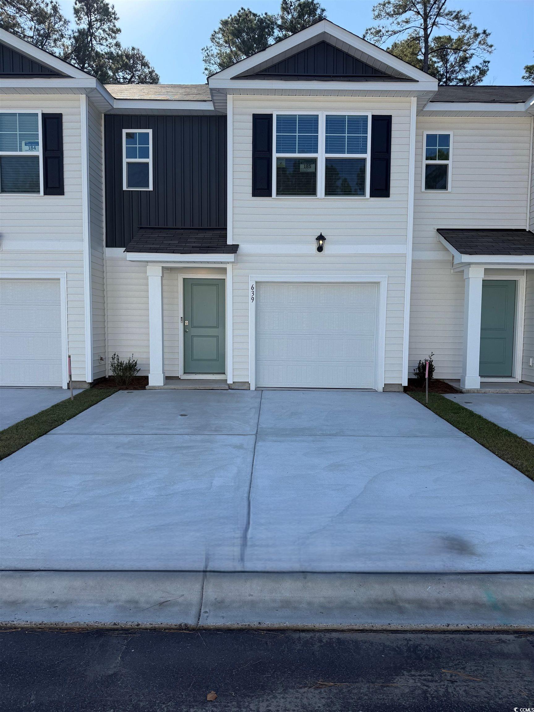 639 Golden Resin Road, Unit LOT 185 Conway, SC 29526 - Photo 1 of 40 View of front facade with board and batten siding, concrete driveway, roof with shingles, and a garage
