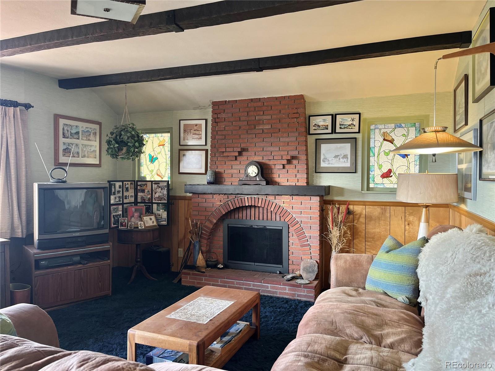 160 South Circle Drive Bailey, CO 80421 - Photo 13 of 26 a living room with furniture and a fireplace