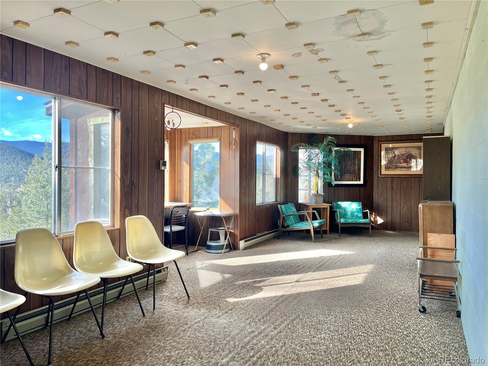 160 South Circle Drive Bailey, CO 80421 - Photo 21 of 26 a living room with furniture and a large window