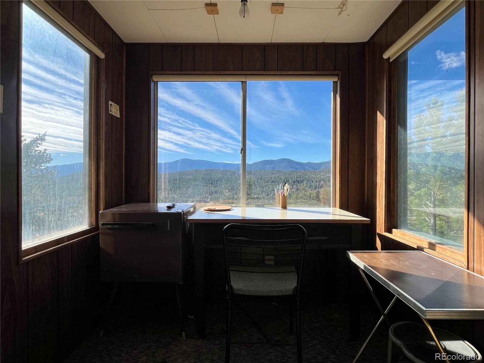 160 South Circle Drive Bailey, CO 80421 - Photo 23 of 26 a view of a dining room with a table and chairs