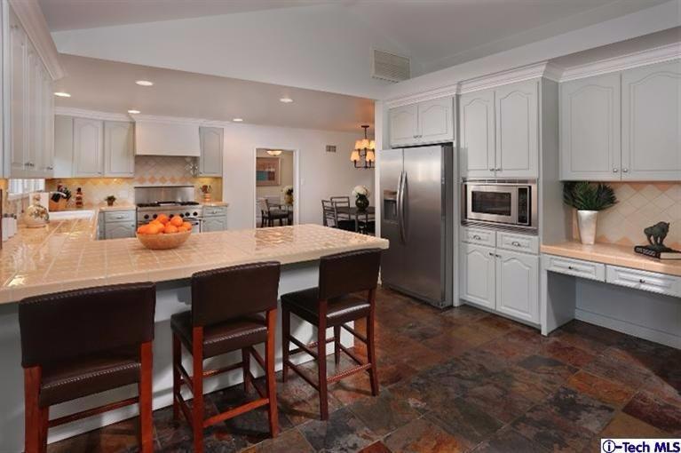 1915 Cañada Boulevard Glendale, CA 91208 - Photo 20 of 42 a kitchen with refrigerator a sink and chairs