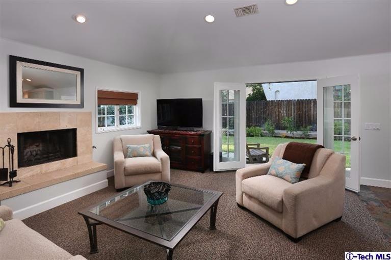 1915 Cañada Boulevard Glendale, CA 91208 - Photo 22 of 42 a living room with furniture a fireplace and a flat screen tv