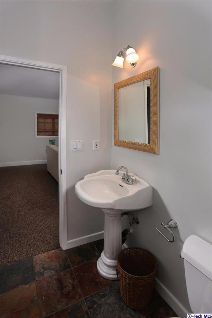 1915 Cañada Boulevard Glendale, CA 91208 - Photo 25 of 42 a bathroom with a sink toilet and mirror