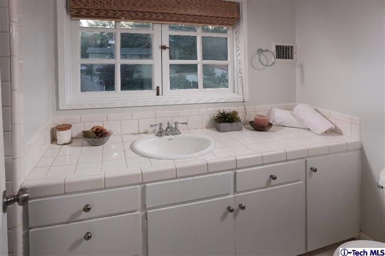 1915 Cañada Boulevard Glendale, CA 91208 - Photo 33 of 42 a bathroom with a sink and a mirror