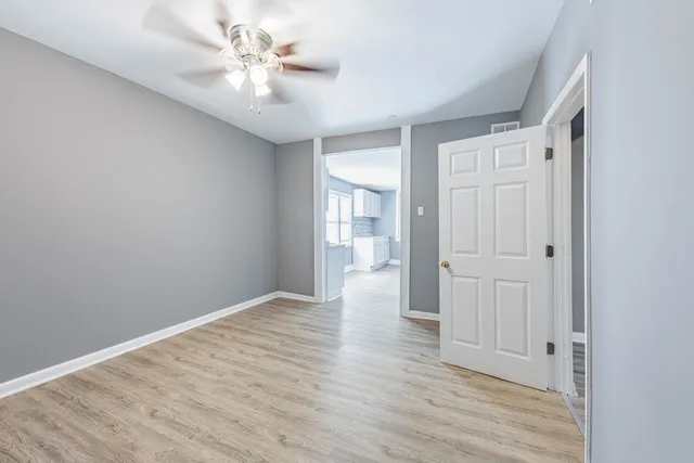 wooden floor in an empty room with a window