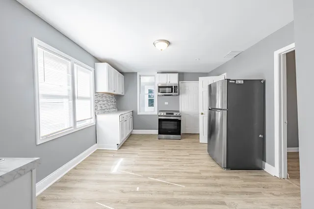 a kitchen with a refrigerator and a sink