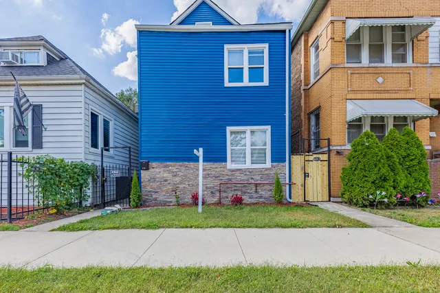a front view of a house with a yard and a garage