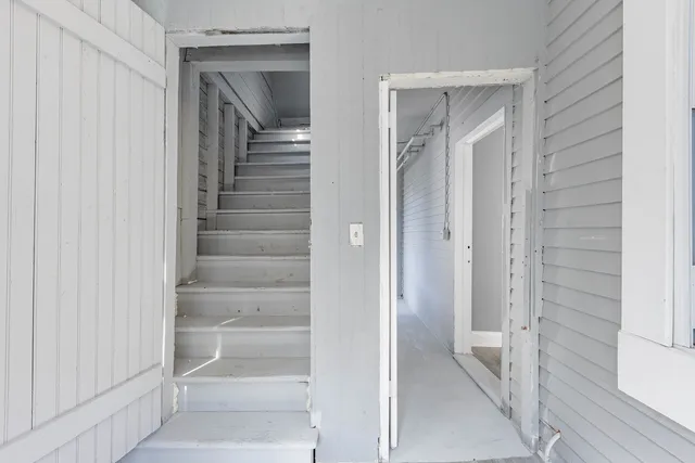 a view of a hallway with wooden floor and entryway