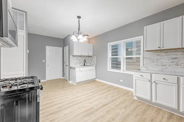 a kitchen with stainless steel appliances granite countertop a stove and a sink