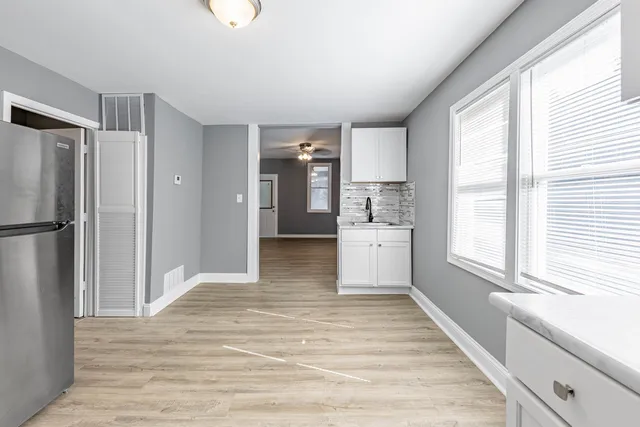 a view of a kitchen with a stove cabinets and wooden floor