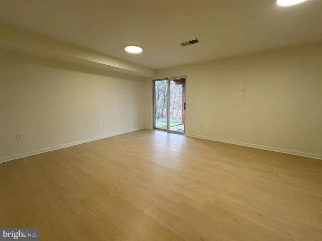 an empty room with a empty space and windows