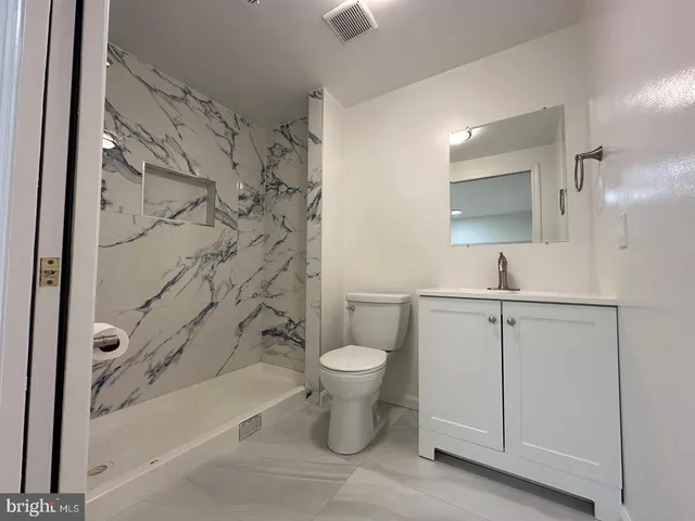 a bathroom with a toilet sink and shower