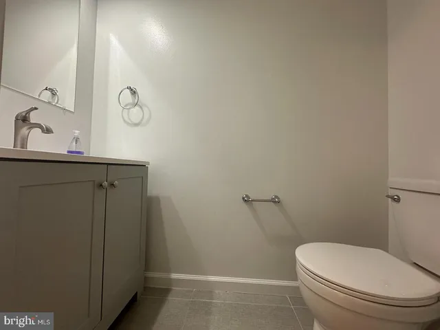 a white toilet sitting next to a bathroom sink