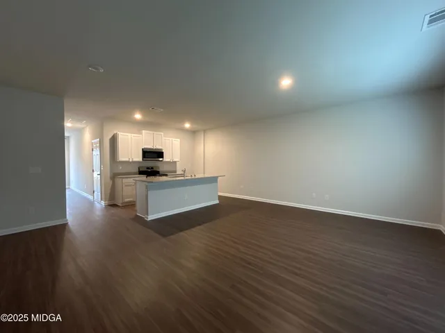 a view of kitchen with granite countertop wall and a refrigerator