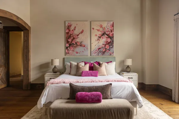 a bedroom with a bed and a painting on the wall