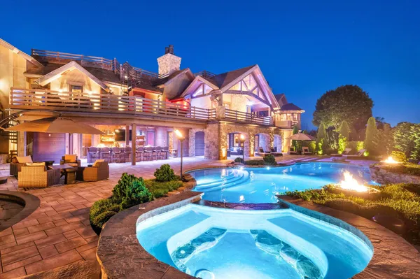 a view of a house with swimming pool yard and sitting area