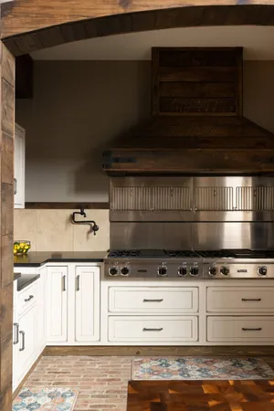 a stove top oven sitting inside of a kitchen