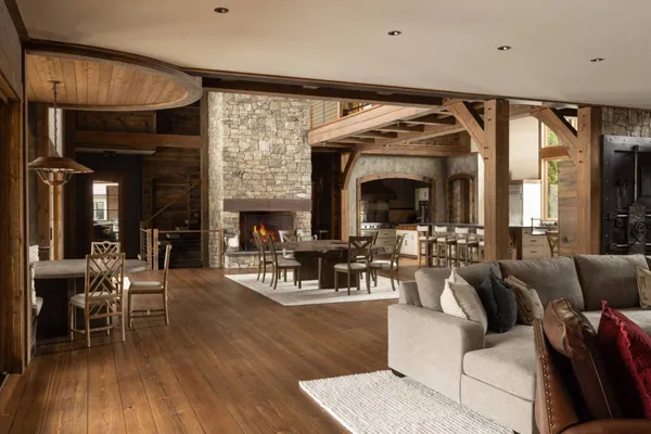 a living room with furniture fireplace and dining table