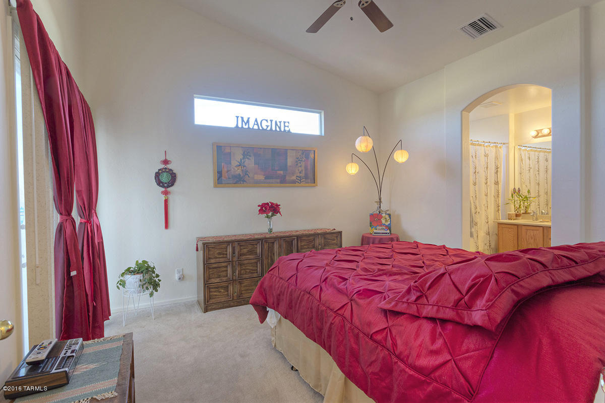1778 Guess Court Rio Rico, AZ 85648 - Photo 12 of 19 a bedroom with a bed and a mirror