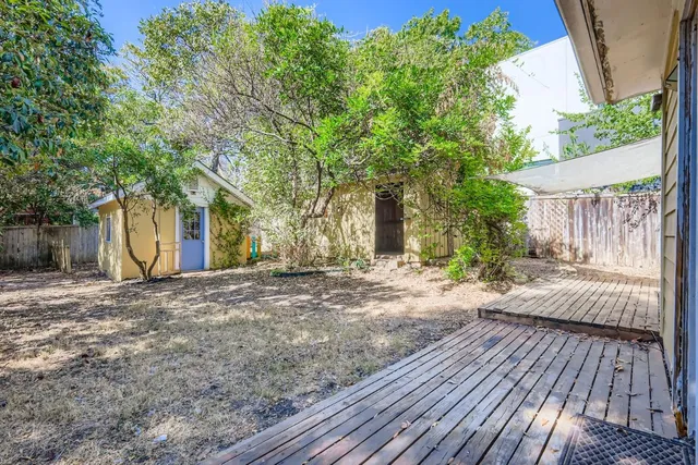 a view of backyard with a garden and trees