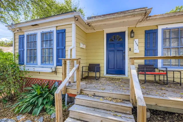 a front view of house with a garden