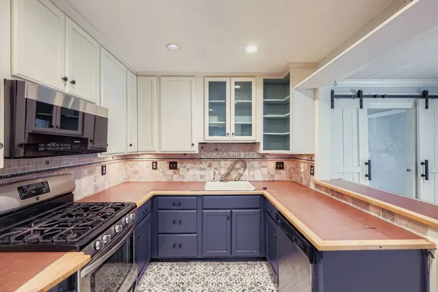a kitchen with a sink stove and microwave