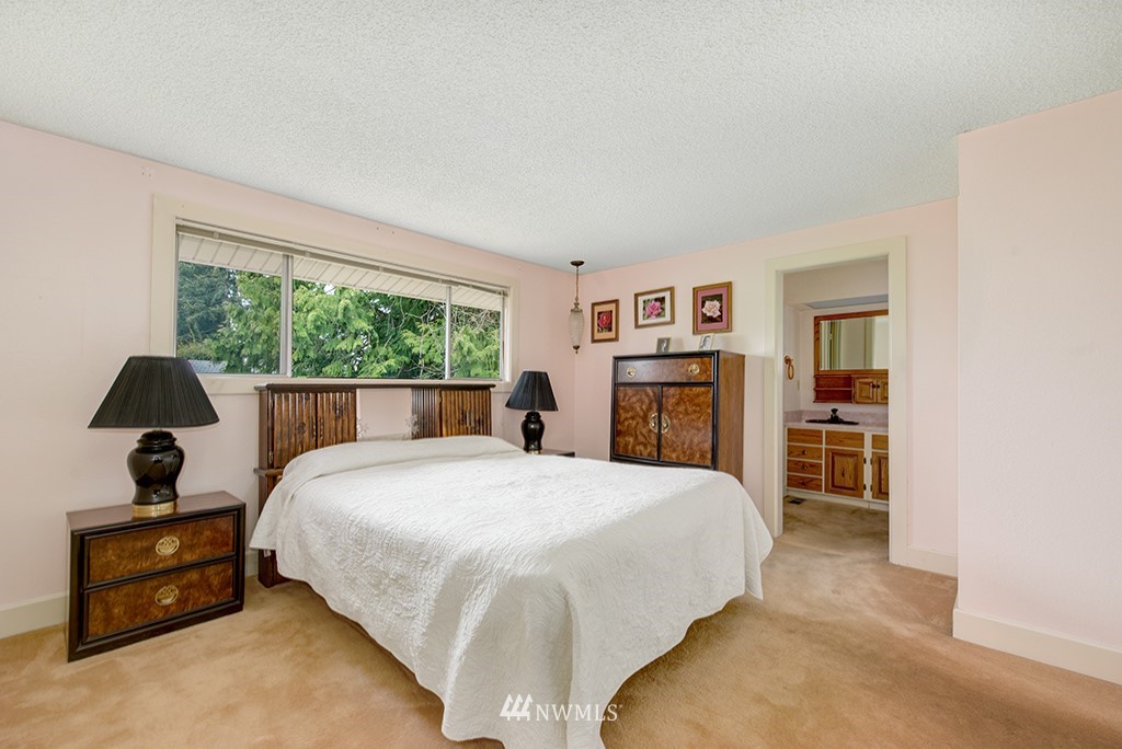 807 Union Street Northeast Renton, WA 98056 - Photo 17 of 38 a spacious bedroom with a bed and a dresser next to a window