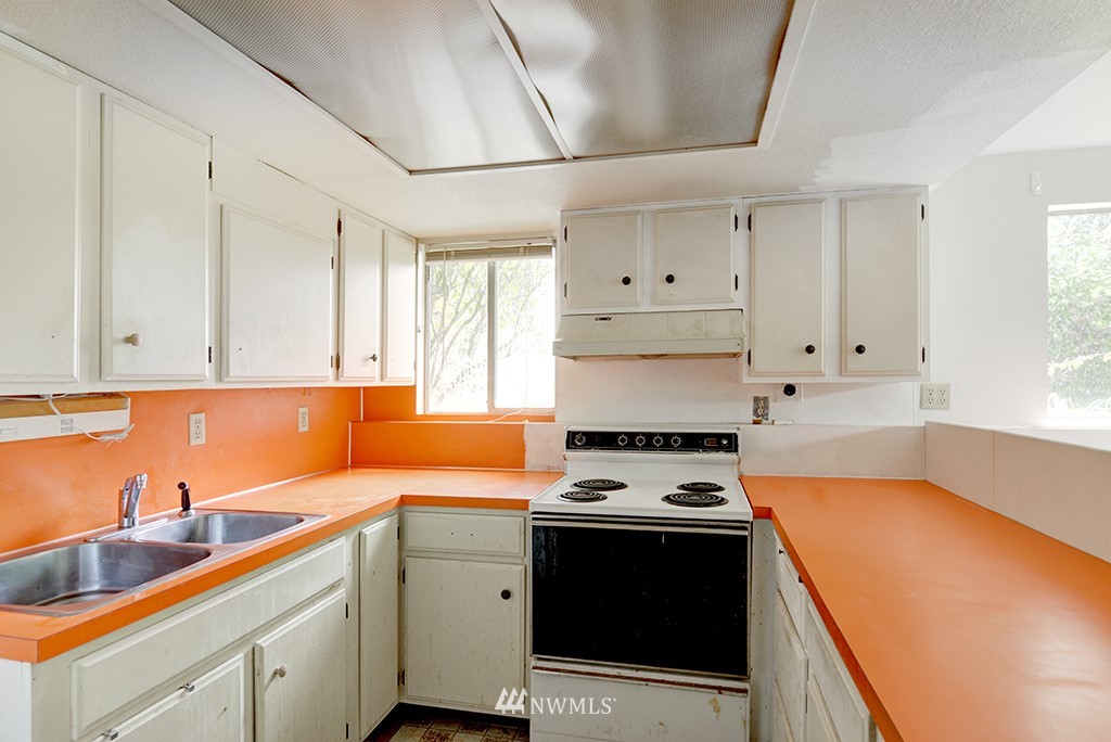 807 Union Street Northeast Renton, WA 98056 - Photo 23 of 38 a kitchen with cabinets appliances a sink and a window