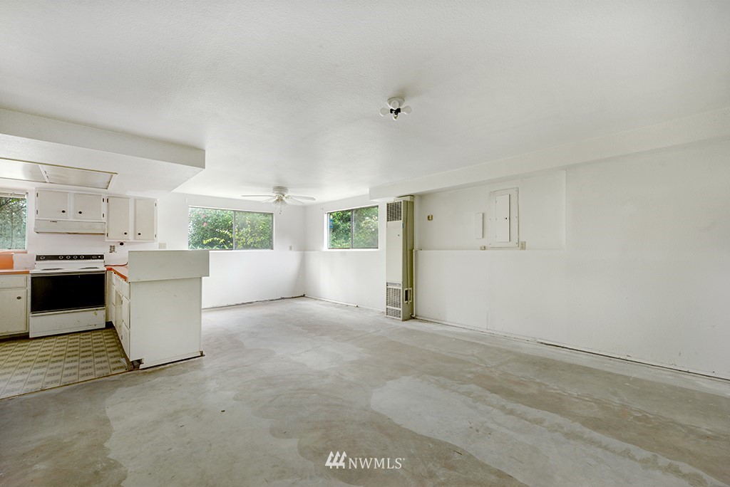 807 Union Street Northeast Renton, WA 98056 - Photo 24 of 38 a view of a kitchen with white cabinets and wooden floor