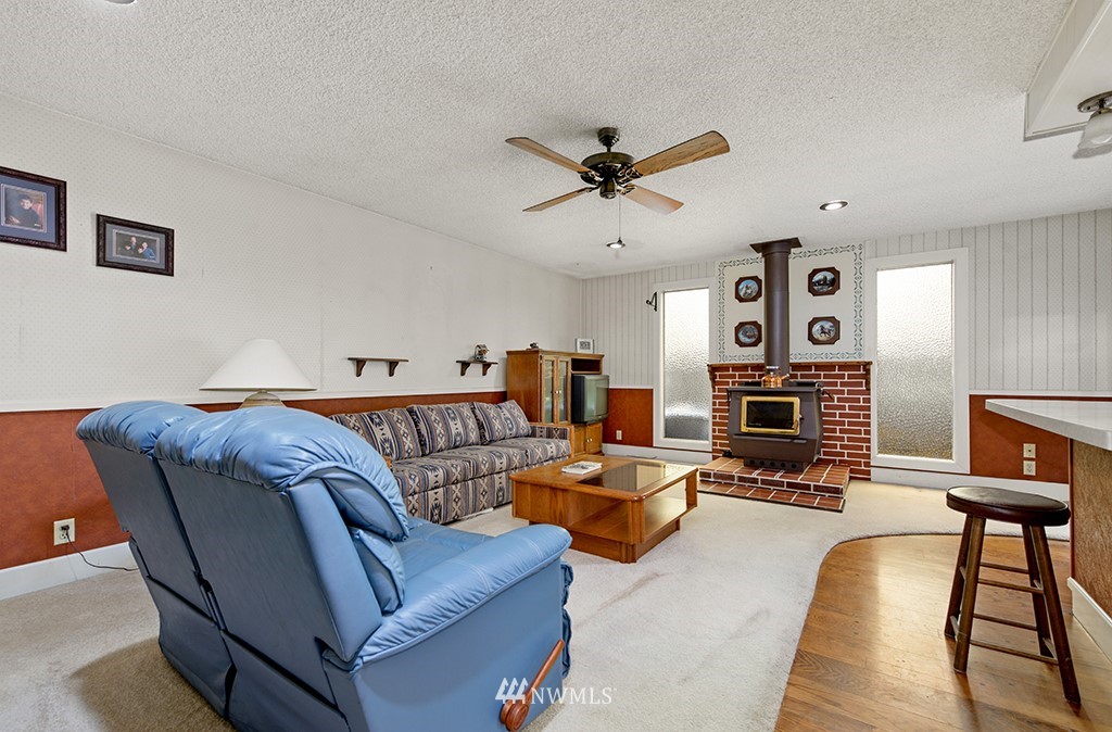 807 Union Street Northeast Renton, WA 98056 - Photo 4 of 38 a living room with furniture a fireplace and a flat screen tv